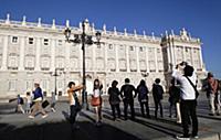Spain, Madrid, Tourists pose for photographs in fr
