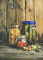 Autumn seasonal pickled vegetables and fruit in gl