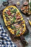 Pizza with mozzarella, figs, black grapes, hamon a