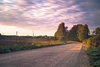 Countryside dirt road. Rural landscape taken in su
